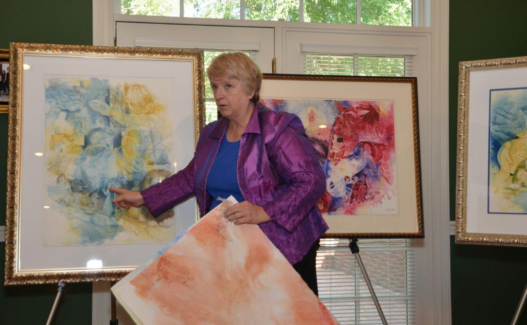 Cora Renfro, an adjunct instructor in art at Campbellsville University, demonstrates how she produces her artwork at a meeting of the Campbellsville University Women’s Alliance. (Campbellsville University Photo by Joan C. McKinney)