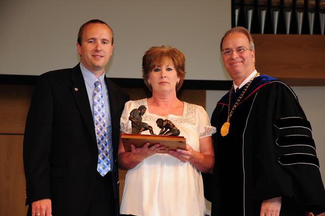 Donna Wilson, center, was the recipient of the staff Servant Leadership Award at Campbellsville University recently. She is with Dr. Michael V. Carter, president, and Tim Judd, comptroller. (Campbellsville University Photo by Ashley Wilson)