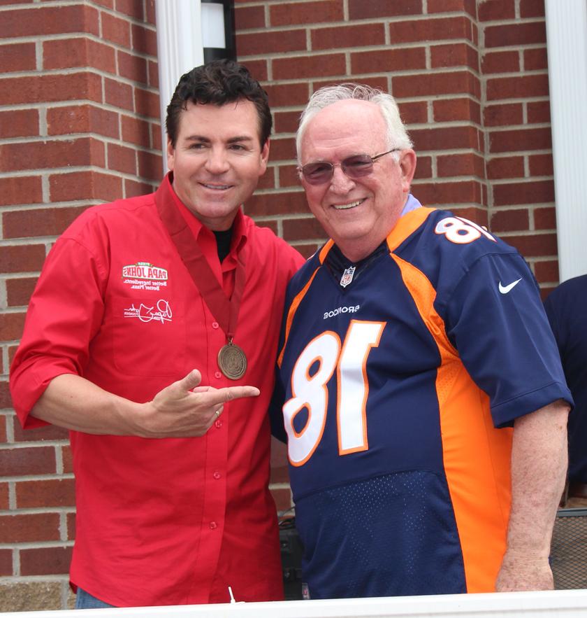 Dr. Joe Early Sr., who appeared as "Peyton Manning," visits with "Papa" John Schnatter at the grand opening. (Campbellsville University Photo by Drew Tucker)