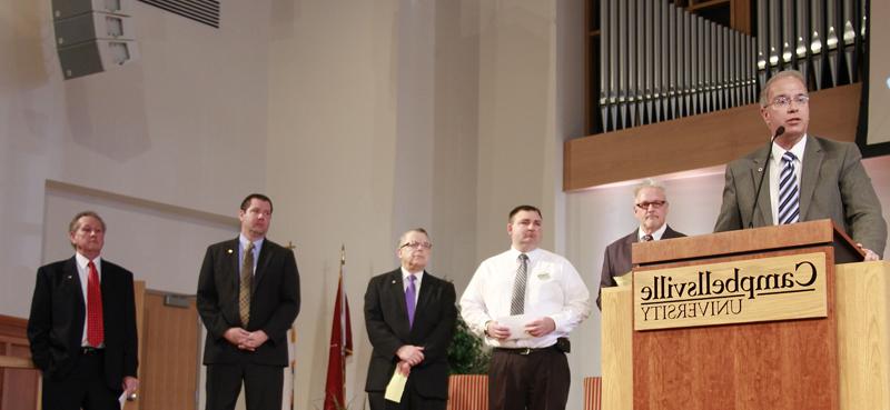 Dr. Michael V. Carter, president of Campbellsville University, answers questions at the first chapel at CU Jan. 15. Others responding to student questions include from left: Dave Walters, vice president for admissions and student services; Heith Hall, director of food service for Pioneer College Caterers Inc.; Dr. John Chowning, vice president for church and external relations and executive assistant to the president; Benji Kelly, vice president for development; and Dr. Frank Cheatham, senior vice president for academic affairs. (Campbellsville University Photo by Rachel DeCoursey)